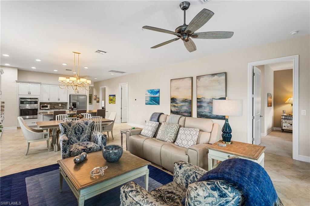 7825 Hawthorne Drive, Unit 2104 Naples, FL 34113 - Photo 13 of 43 a living room with furniture and kitchen view