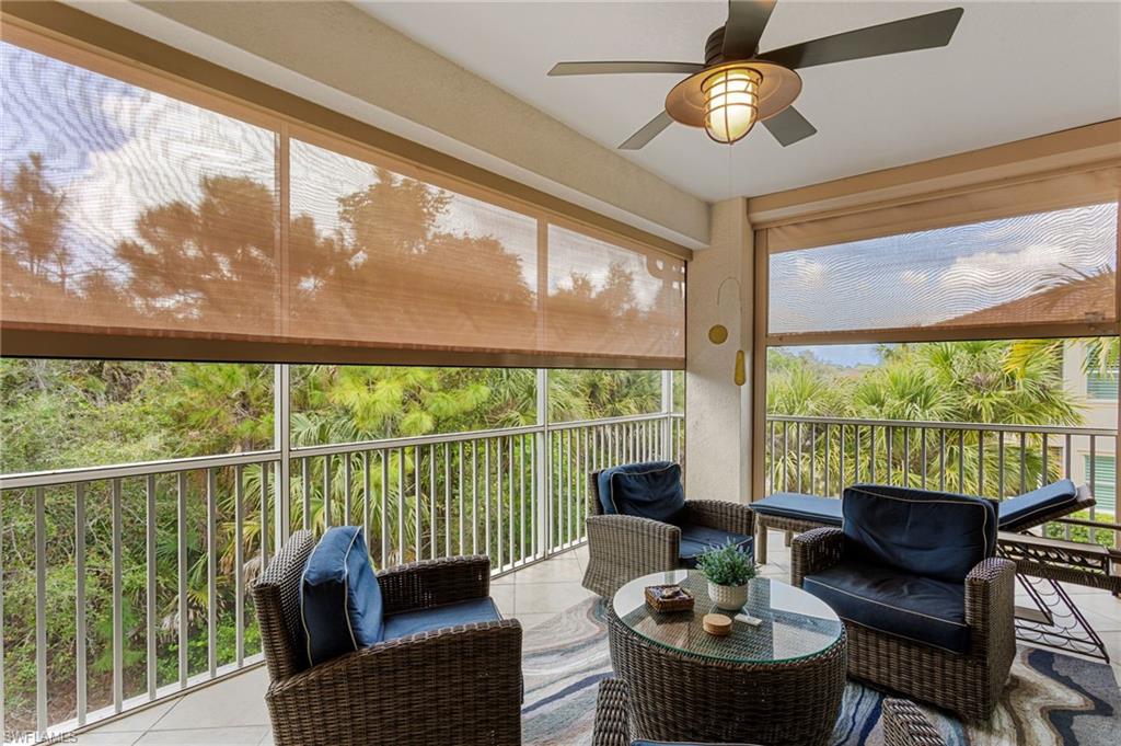 7825 Hawthorne Drive, Unit 2104 Naples, FL 34113 - Photo 14 of 43 a living room with furniture and a large window