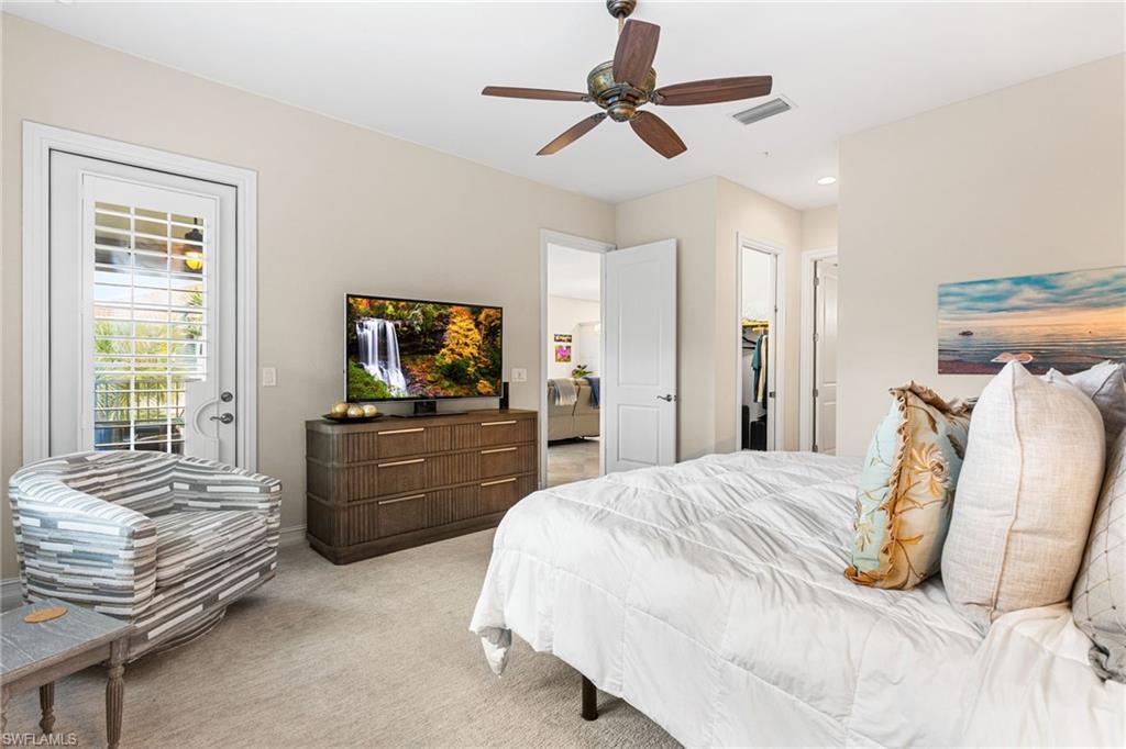 7825 Hawthorne Drive, Unit 2104 Naples, FL 34113 - Photo 17 of 43 a bedroom with a bed and a flat screen tv