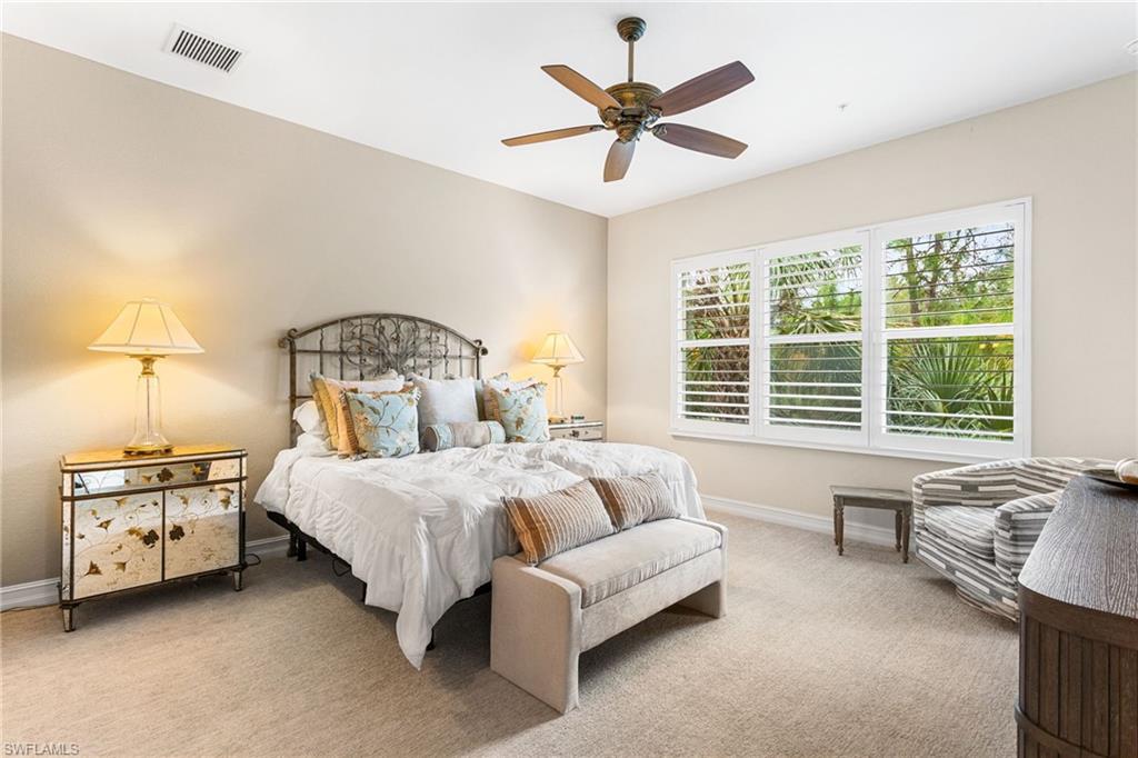 7825 Hawthorne Drive, Unit 2104 Naples, FL 34113 - Photo 18 of 43 a bedroom with a bed a couch and a window
