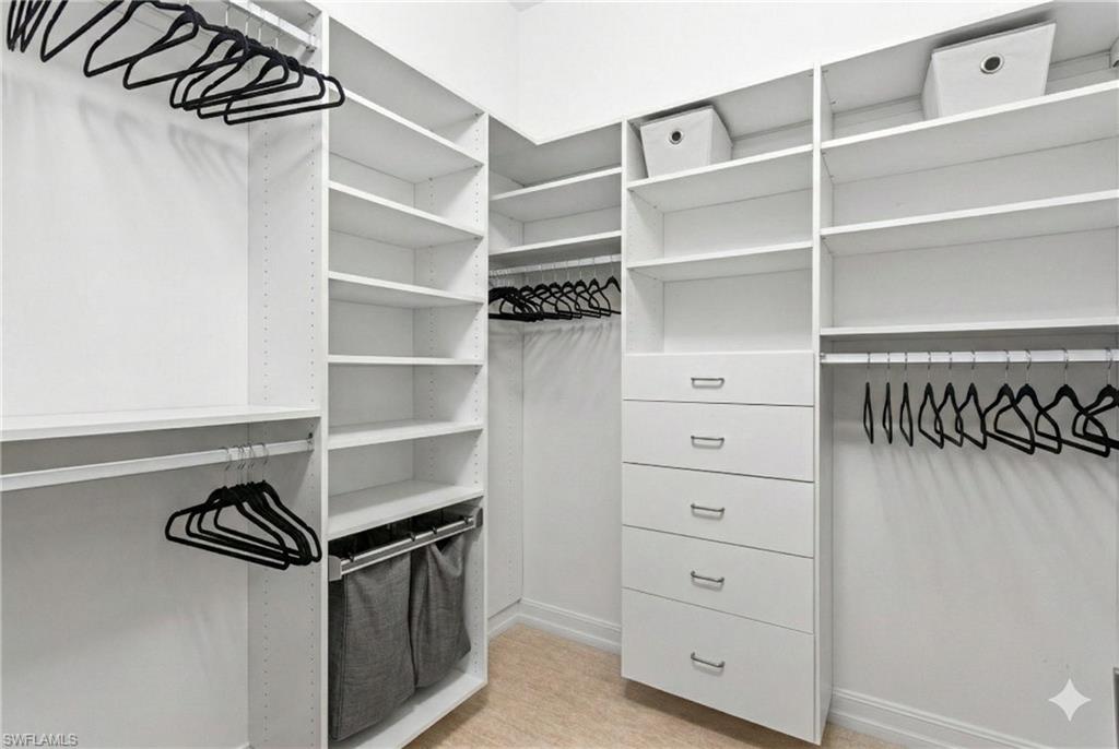 7825 Hawthorne Drive, Unit 2104 Naples, FL 34113 - Photo 23 of 43 a view of walk in closet with empty racks
