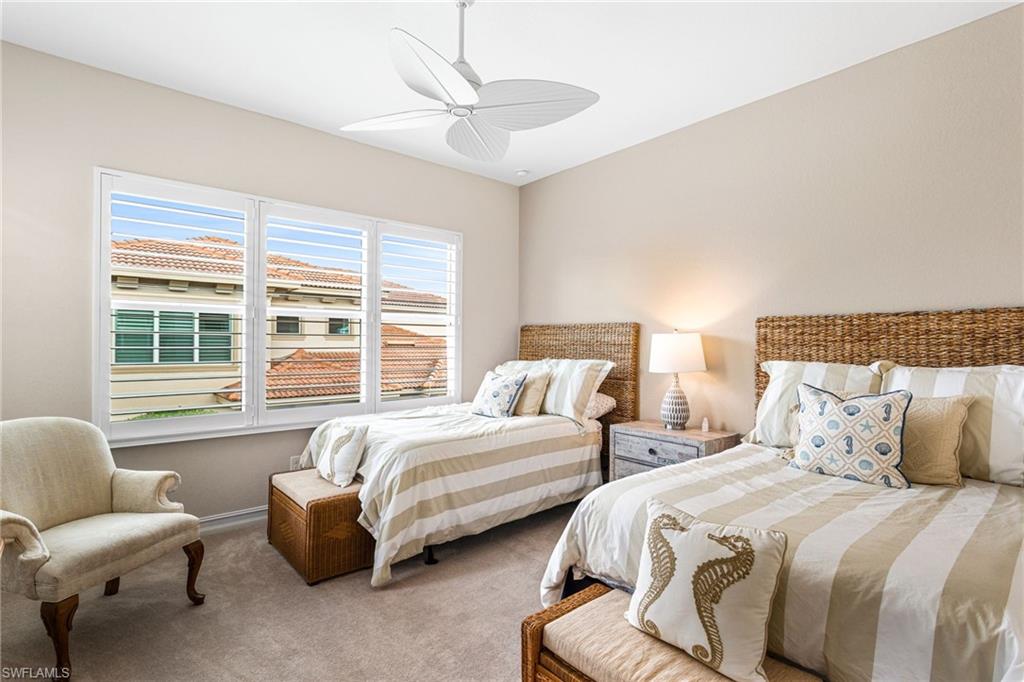 7825 Hawthorne Drive, Unit 2104 Naples, FL 34113 - Photo 24 of 43 a bedroom with two beds and a large window