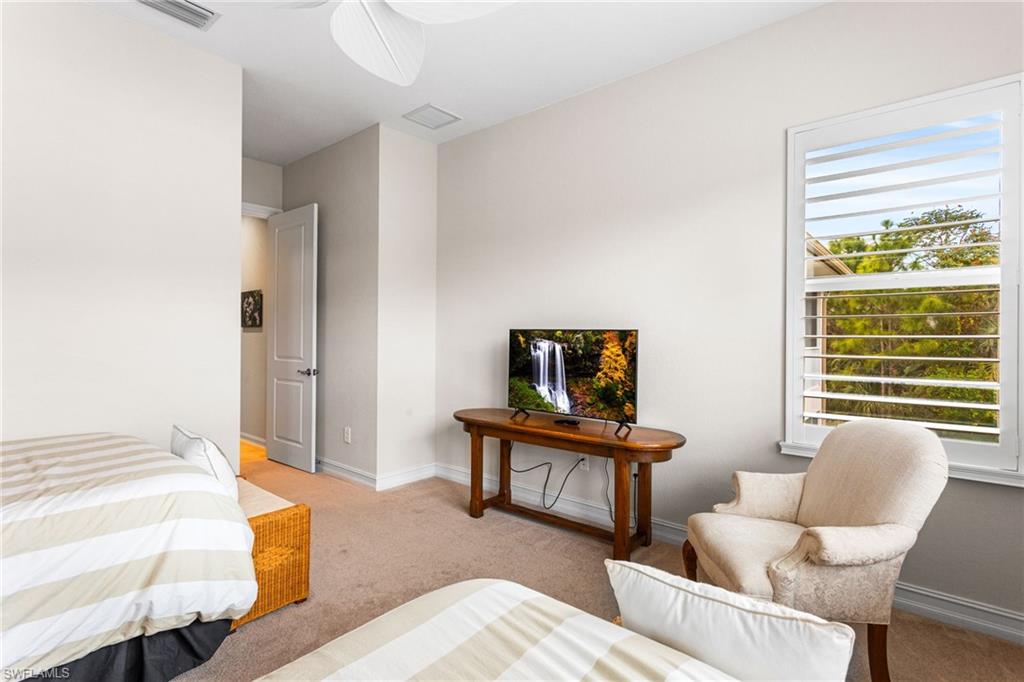 7825 Hawthorne Drive, Unit 2104 Naples, FL 34113 - Photo 25 of 43 a bedroom with furniture and a window