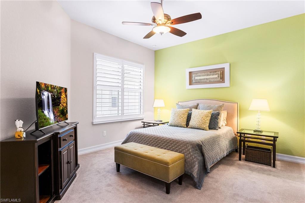 7825 Hawthorne Drive, Unit 2104 Naples, FL 34113 - Photo 27 of 43 a bedroom with a bed and a flat screen tv