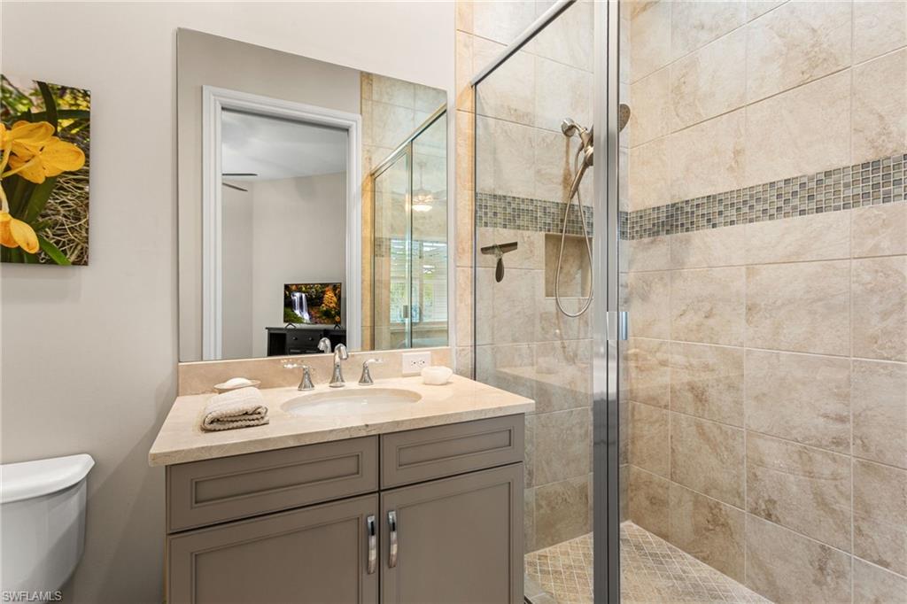 7825 Hawthorne Drive, Unit 2104 Naples, FL 34113 - Photo 29 of 43 a bathroom with a sink a toilet and shower