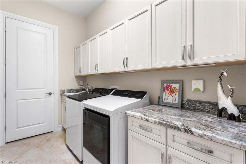7825 Hawthorne Drive, Unit 2104 Naples, FL 34113 - Photo 30 of 43 a kitchen with granite countertop white cabinets and a stove