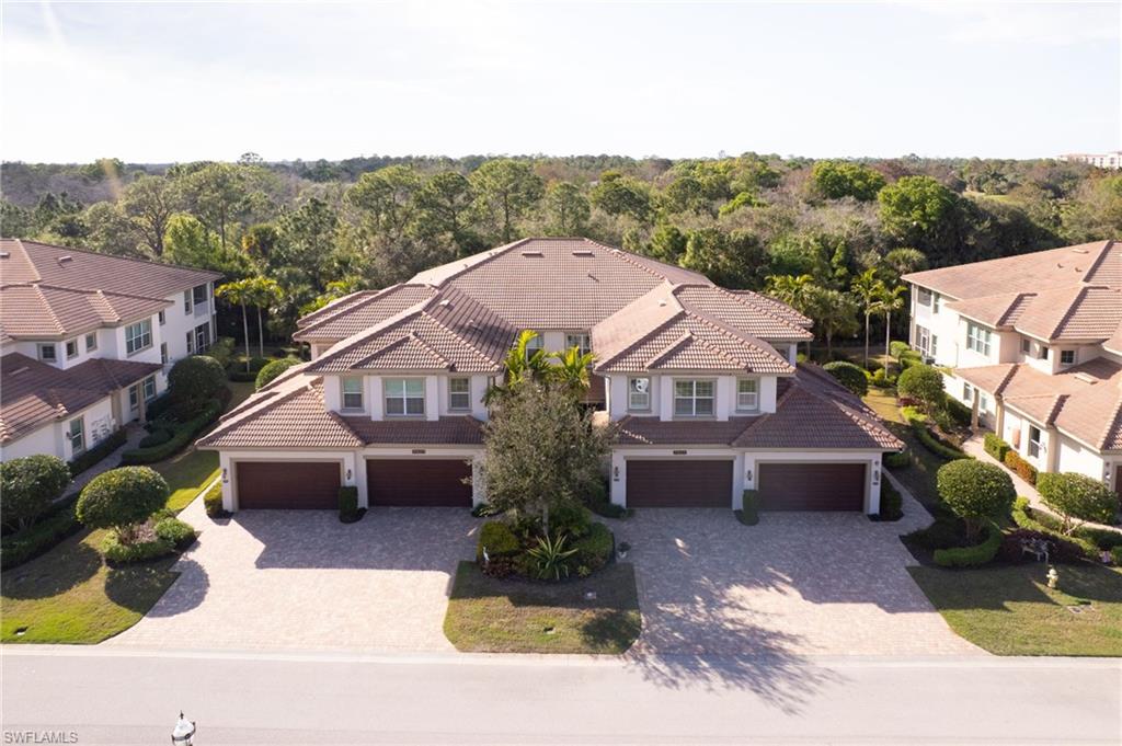 7825 Hawthorne Drive, Unit 2104 Naples, FL 34113 - Photo 32 of 43 a front view of a house with a yard
