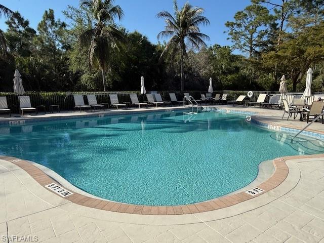 7825 Hawthorne Drive, Unit 2104 Naples, FL 34113 - Photo 36 of 43 a view of a swimming pool with a garden