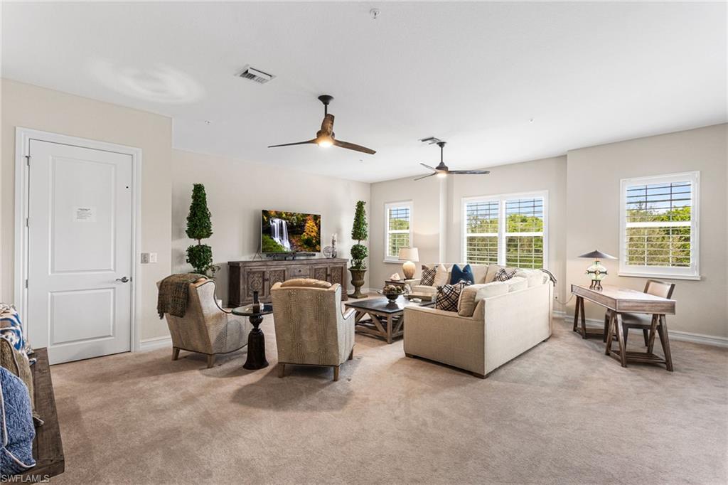 7825 Hawthorne Drive, Unit 2104 Naples, FL 34113 - Photo 5 of 43 a living room with furniture and a large window