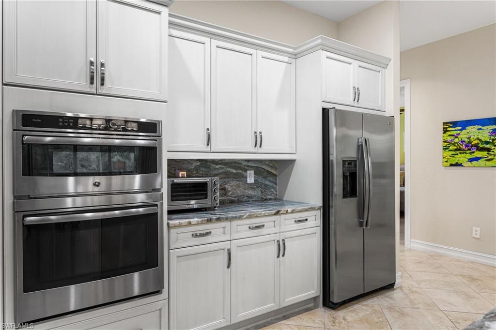 7825 Hawthorne Drive, Unit 2104 Naples, FL 34113 - Photo 8 of 43 a kitchen with appliances cabinets and a counter top space
