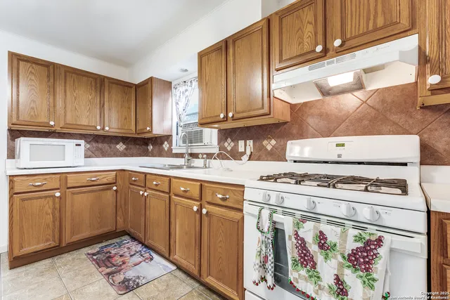 a kitchen with cabinets appliances and a counter top space