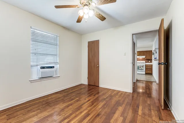 wooden floor in an empty room with a window