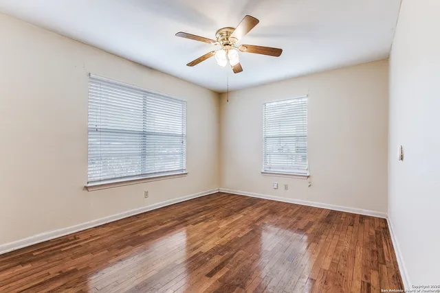 wooden floor in an empty room with a window