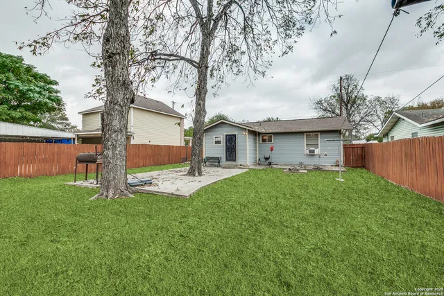 a view of a house with yard and a tree