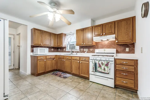 a kitchen with a stove microwave and refrigerator