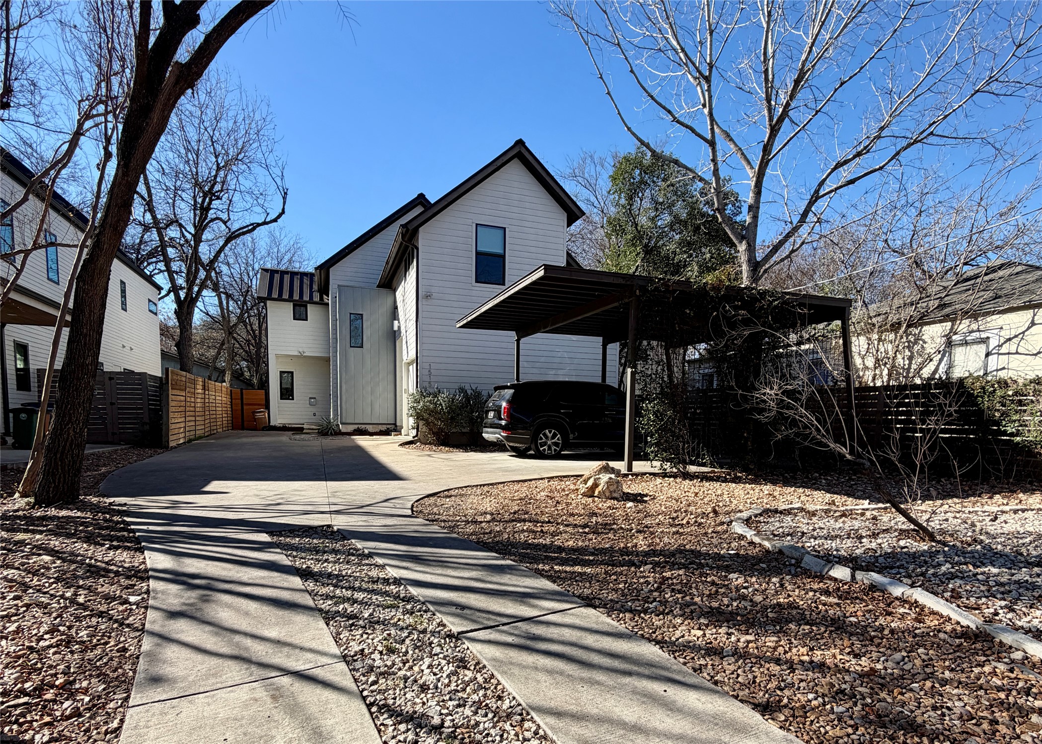 1515 Hether Street, Unit B Austin, TX 78704 - Photo 2 of 30 A contemporary white home offers ample parking with a spacious driveway and convenient carport.