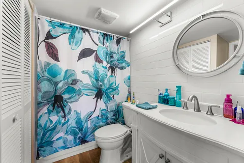 a bathroom with a toilet sink and mirror
