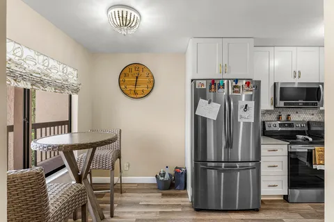 a kitchen with stainless steel appliances granite countertop a refrigerator and a stove