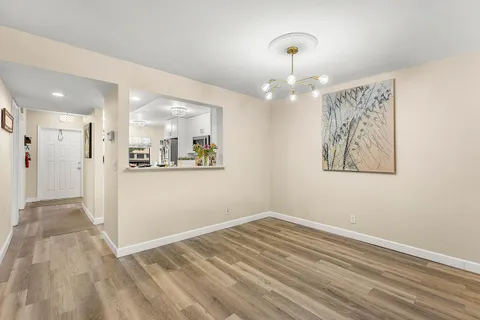 a view of a hallway with wooden floor and a large window