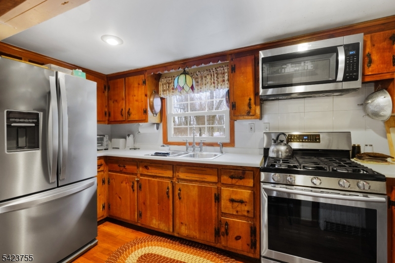 691 Ridgedale Avenue East Hanover, NJ 07936 - Photo 15 of 49 a kitchen with stainless steel appliances granite countertop a stove microwave refrigerator and sink