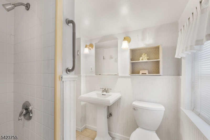 691 Ridgedale Avenue East Hanover, NJ 07936 - Photo 19 of 49 a bathroom with a toilet a sink and a mirror