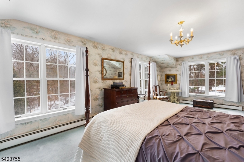 691 Ridgedale Avenue East Hanover, NJ 07936 - Photo 22 of 49 a bedroom with a large bed and a large window