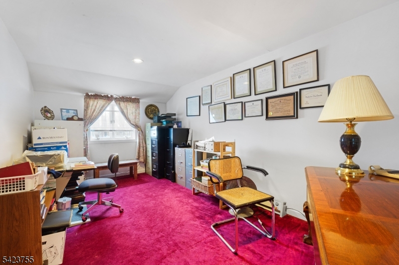 691 Ridgedale Avenue East Hanover, NJ 07936 - Photo 33 of 49 a living room with furniture gym equipment and a window