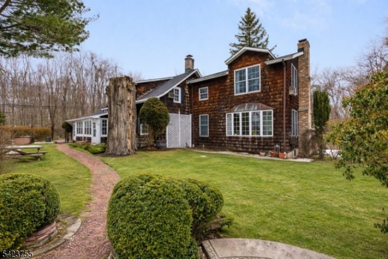 691 Ridgedale Avenue East Hanover, NJ 07936 - Photo 5 of 49 a front view of a house with a garden