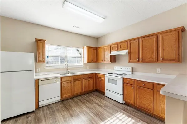 a kitchen with stainless steel appliances granite countertop a stove sink and cabinets