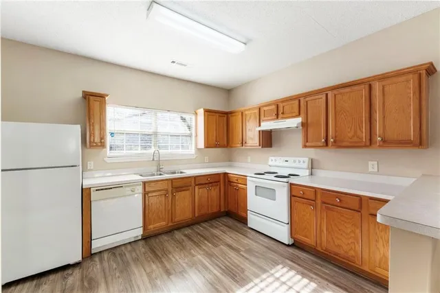 a kitchen with stainless steel appliances granite countertop a stove sink and cabinets