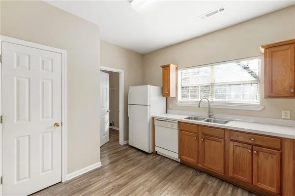 a kitchen with a sink a window and refrigerator