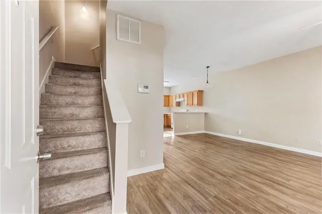 a view of wooden floor and windows in a room
