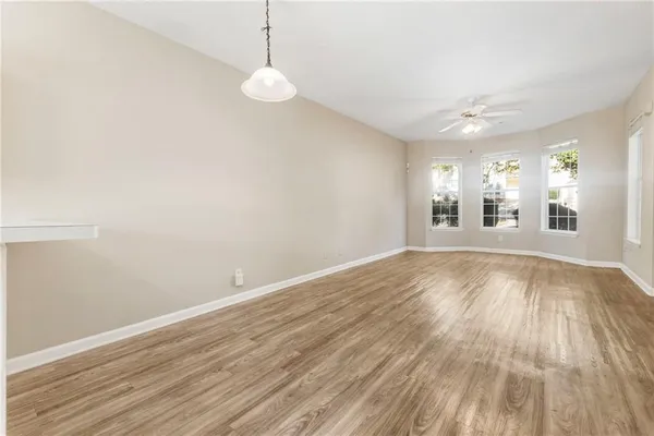 a view of a room with wooden floor and window