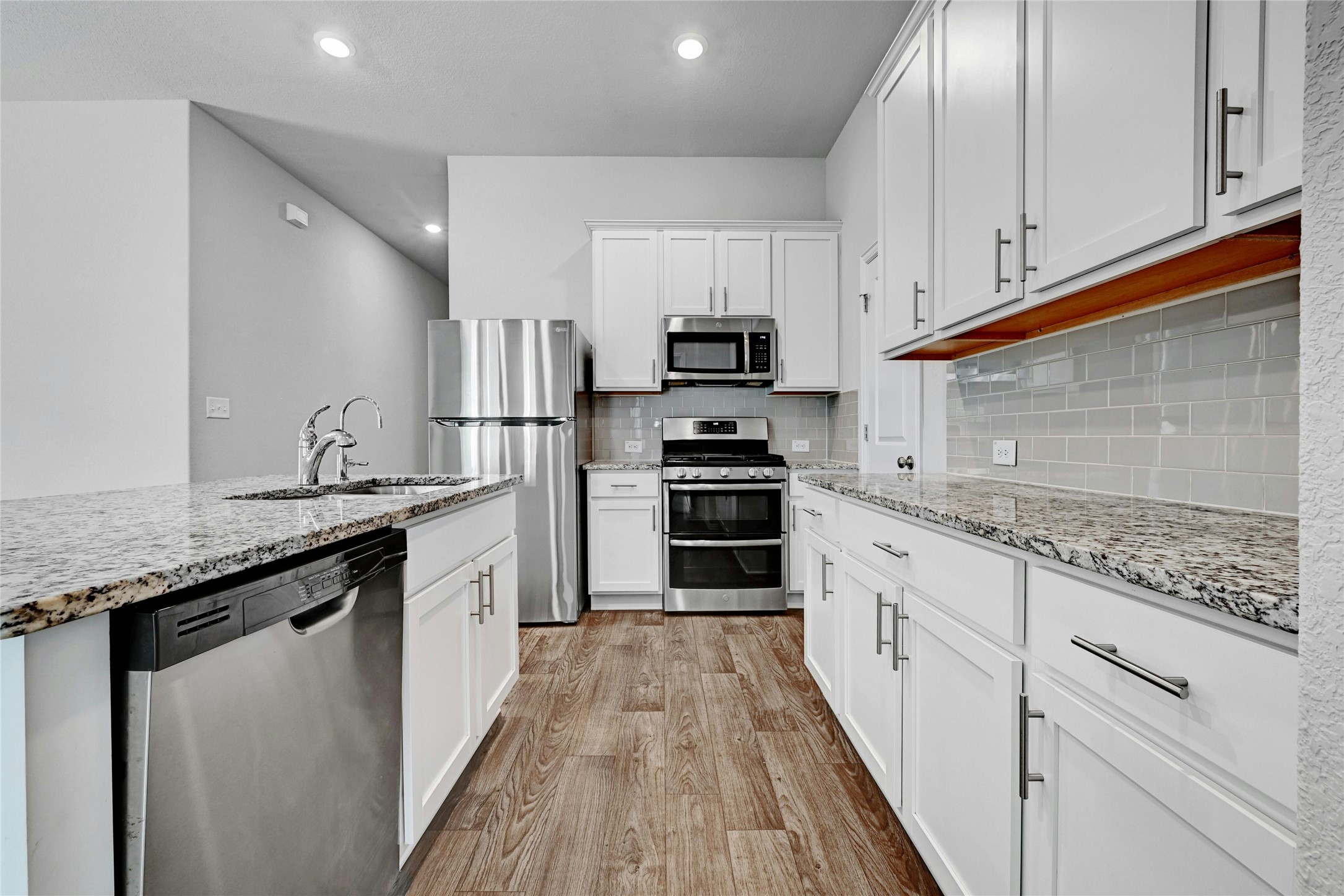 1384 Harwell Loop Kyle, TX 78640 - Photo 12 of 27 a kitchen with granite countertop a sink and steel appliances
