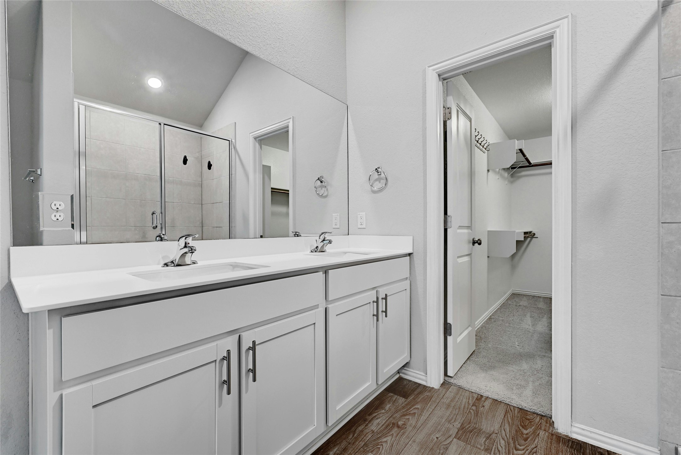 1384 Harwell Loop Kyle, TX 78640 - Photo 15 of 27 a bathroom with a double vanity sink and mirror