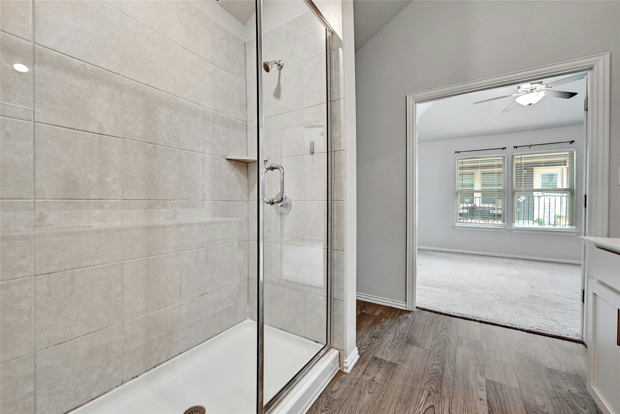 1384 Harwell Loop Kyle, TX 78640 - Photo 16 of 27 a bathroom with a bathtub and a glass door shower