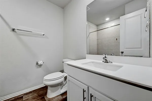 a bathroom with a sink toilet and vanity