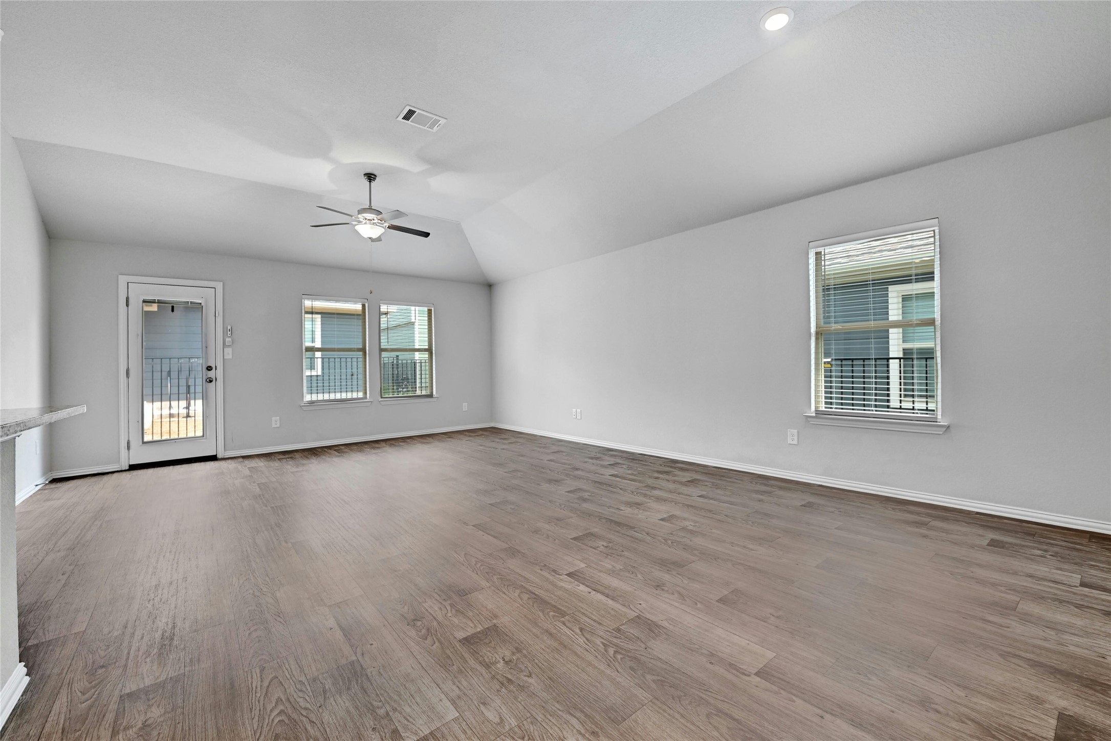 1384 Harwell Loop Kyle, TX 78640 - Photo 6 of 27 a view of an empty room with a window and wooden floor
