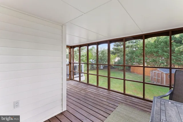 a view of roof deck with wooden floor and seating space