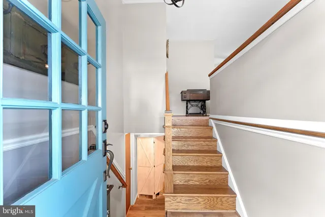 a view of entryway with wooden floor and stairs