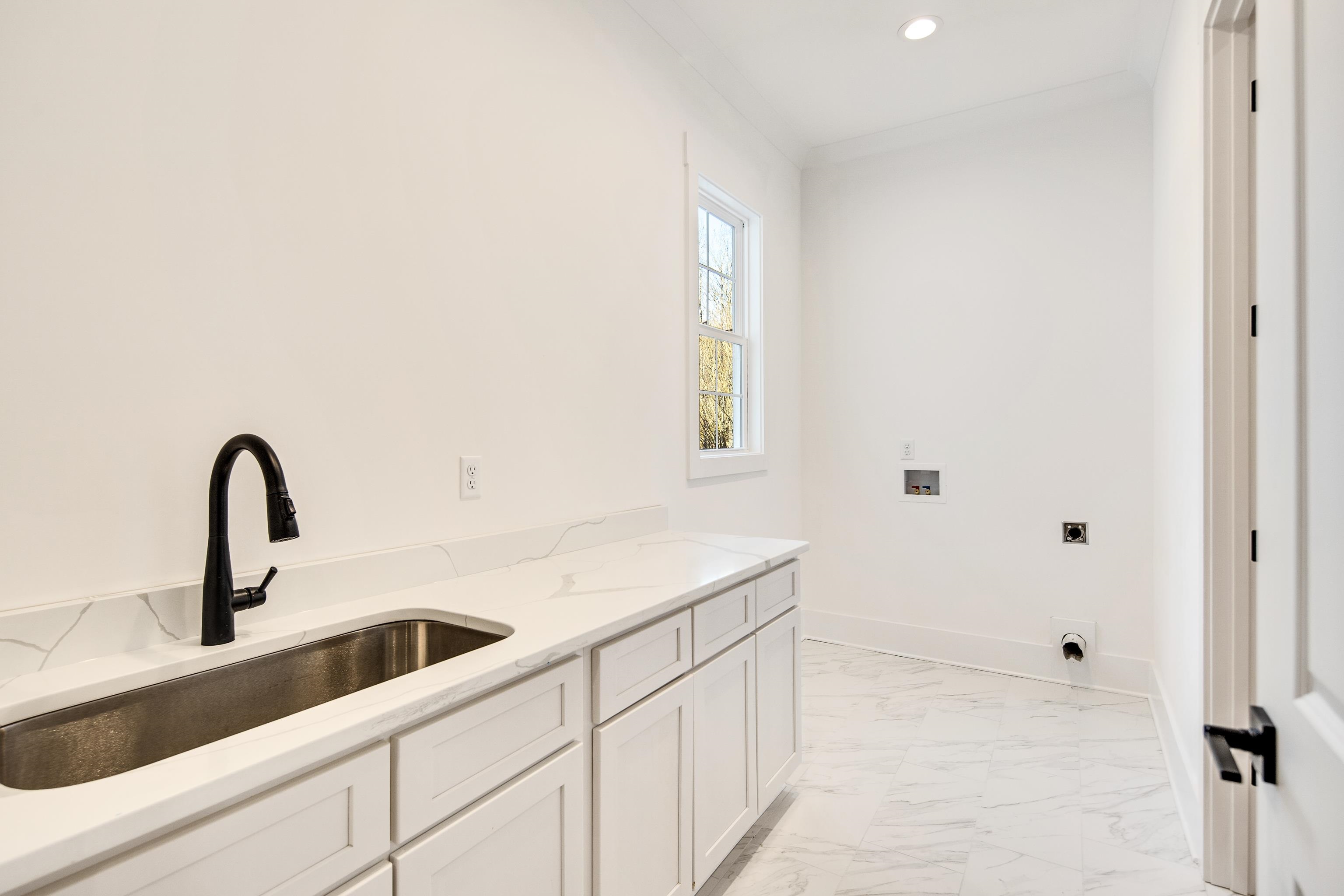 641 Fletcher Road Collierville, TN 38017 - Photo 20 of 37 a kitchen with a sink and cabinets