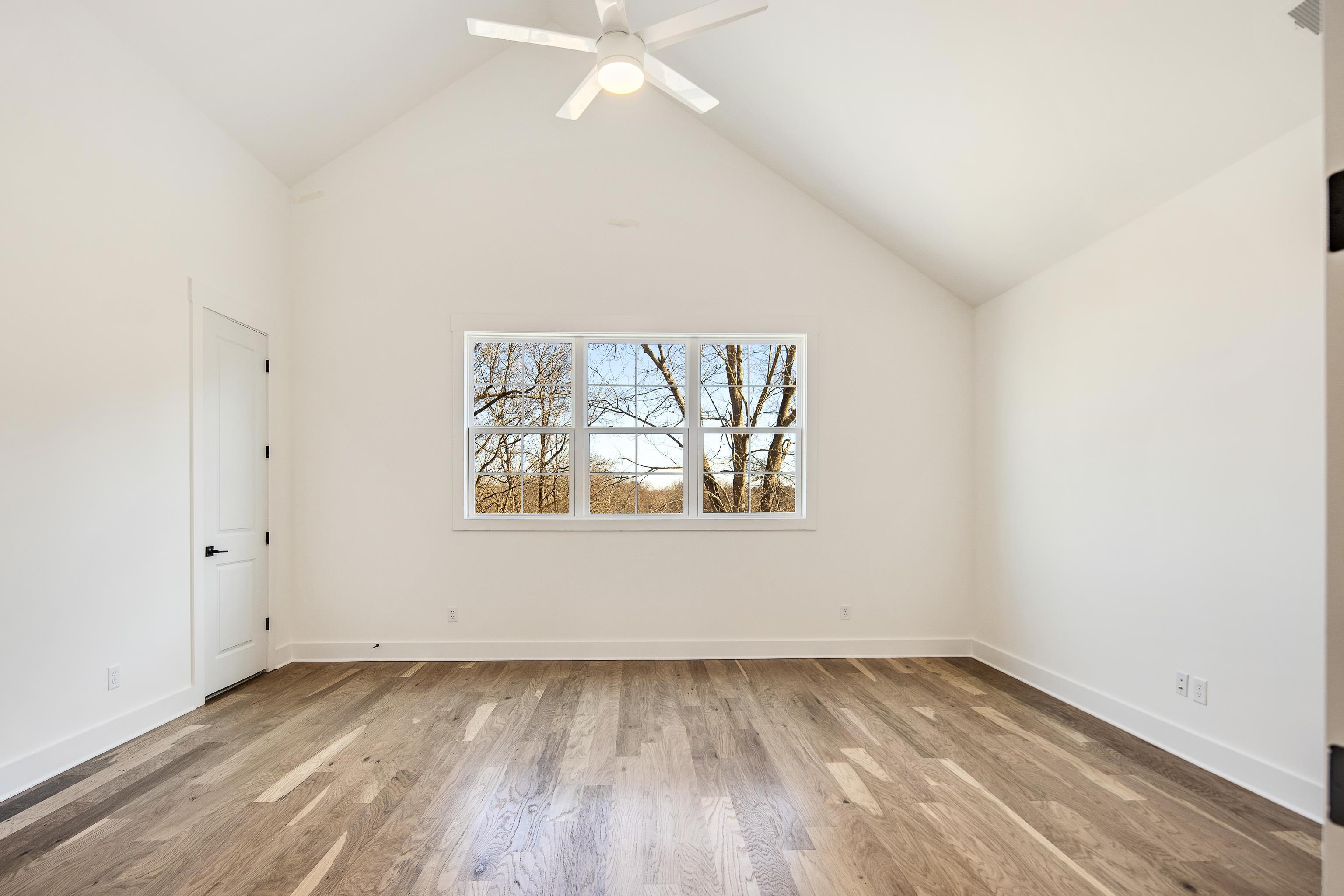 641 Fletcher Road Collierville, TN 38017 - Photo 28 of 37 an empty room with wooden floor and windows