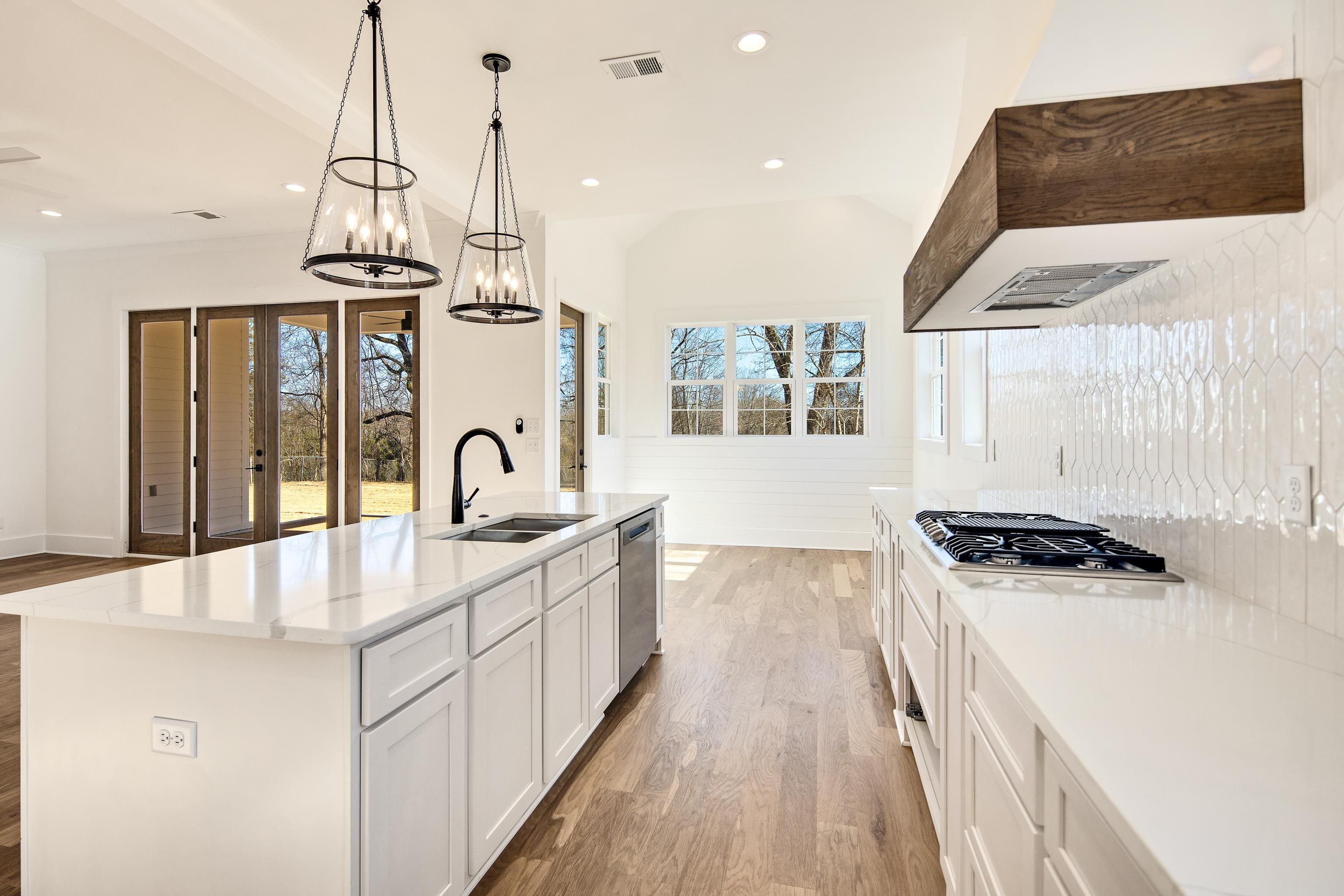 641 Fletcher Road Collierville, TN 38017 - Photo 10 of 37 a kitchen with stainless steel appliances a sink a stove and a wooden floors