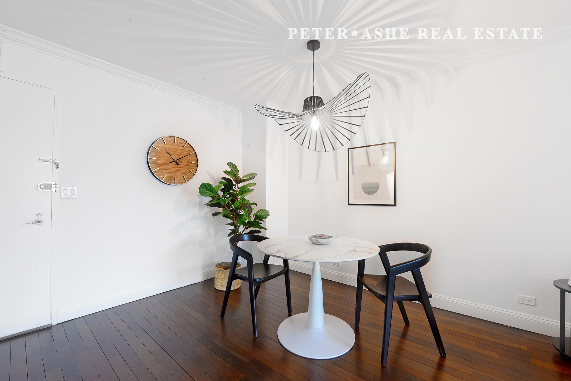 220 East 65th Street, Unit 8J Manhattan, NY 10065 - Photo 3 of 23 a view of a dining room with furniture and wooden floor