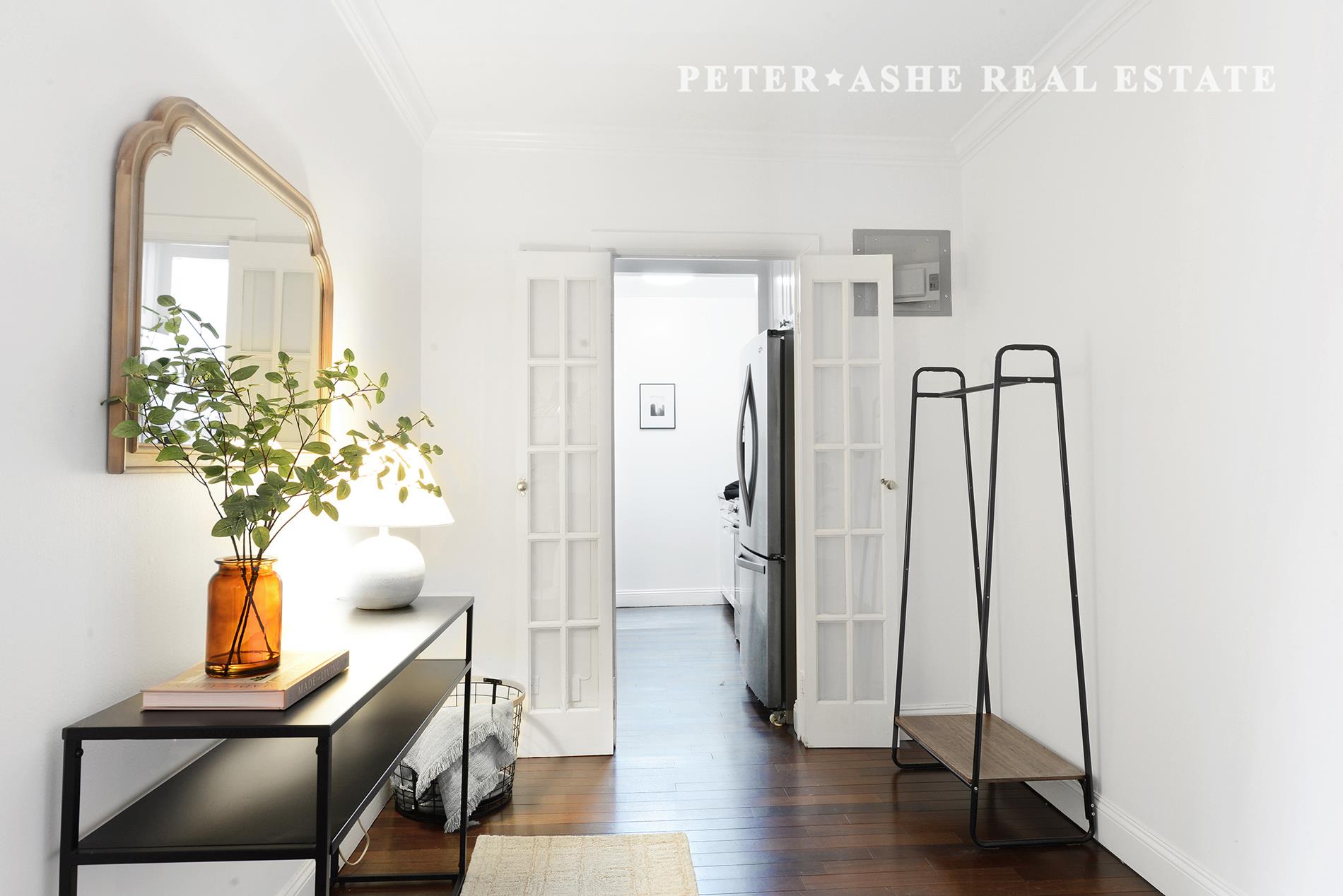 220 East 65th Street, Unit 8J Manhattan, NY 10065 - Photo 4 of 23 a view of entryway with wooden floor