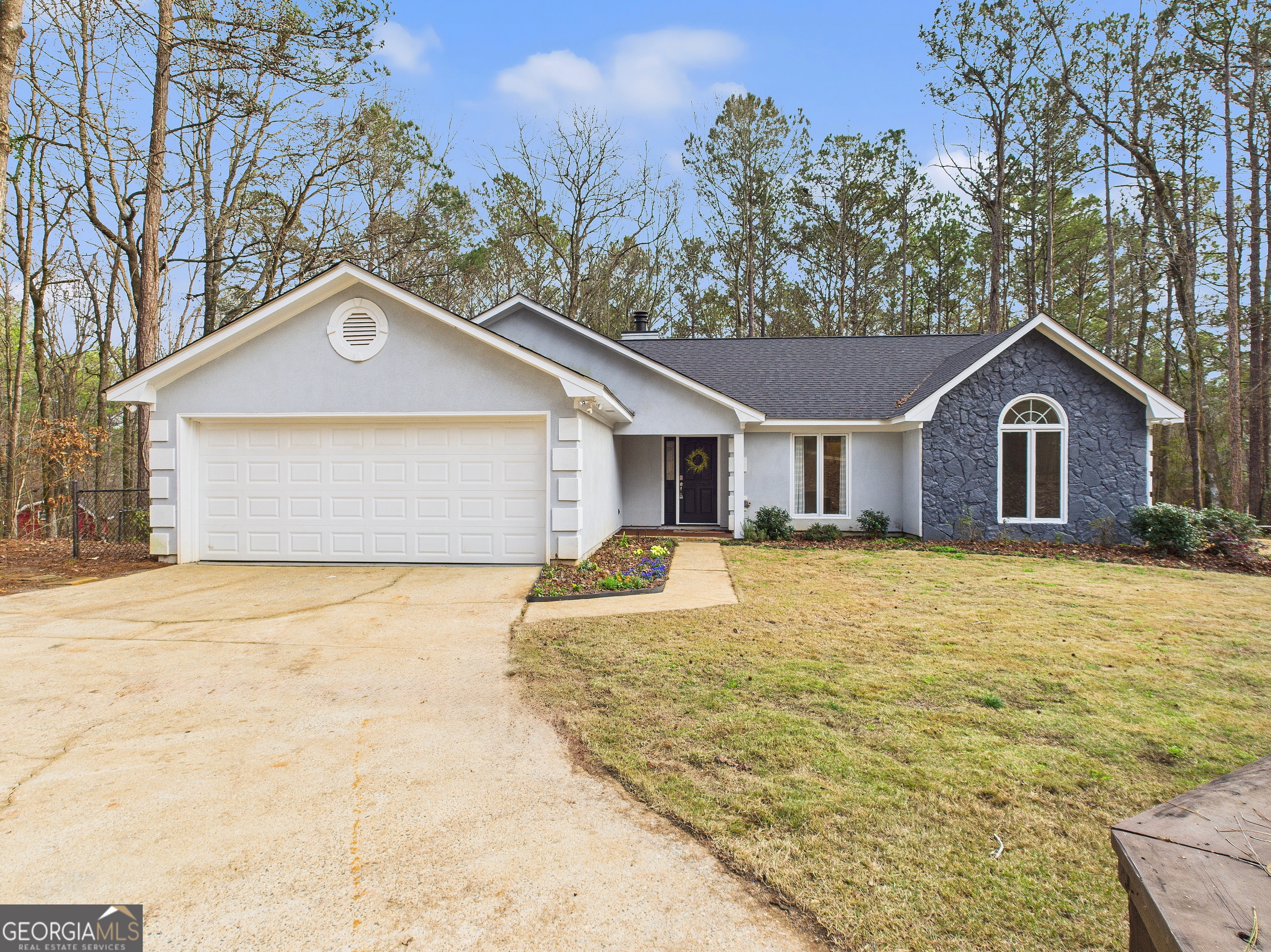 292 Blue Bird Trail Fortson, GA 31808 - Photo 1 of 45 a front view of a house with a garden and tree