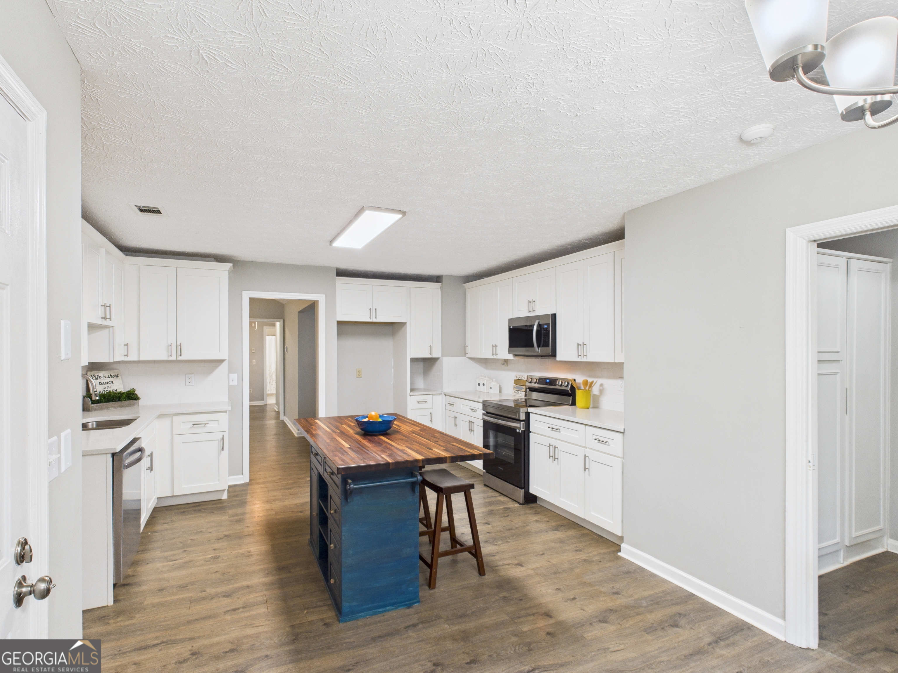 292 Blue Bird Trail Fortson, GA 31808 - Photo 11 of 45 a kitchen with stainless steel appliances granite countertop a refrigerator stove top oven and sink