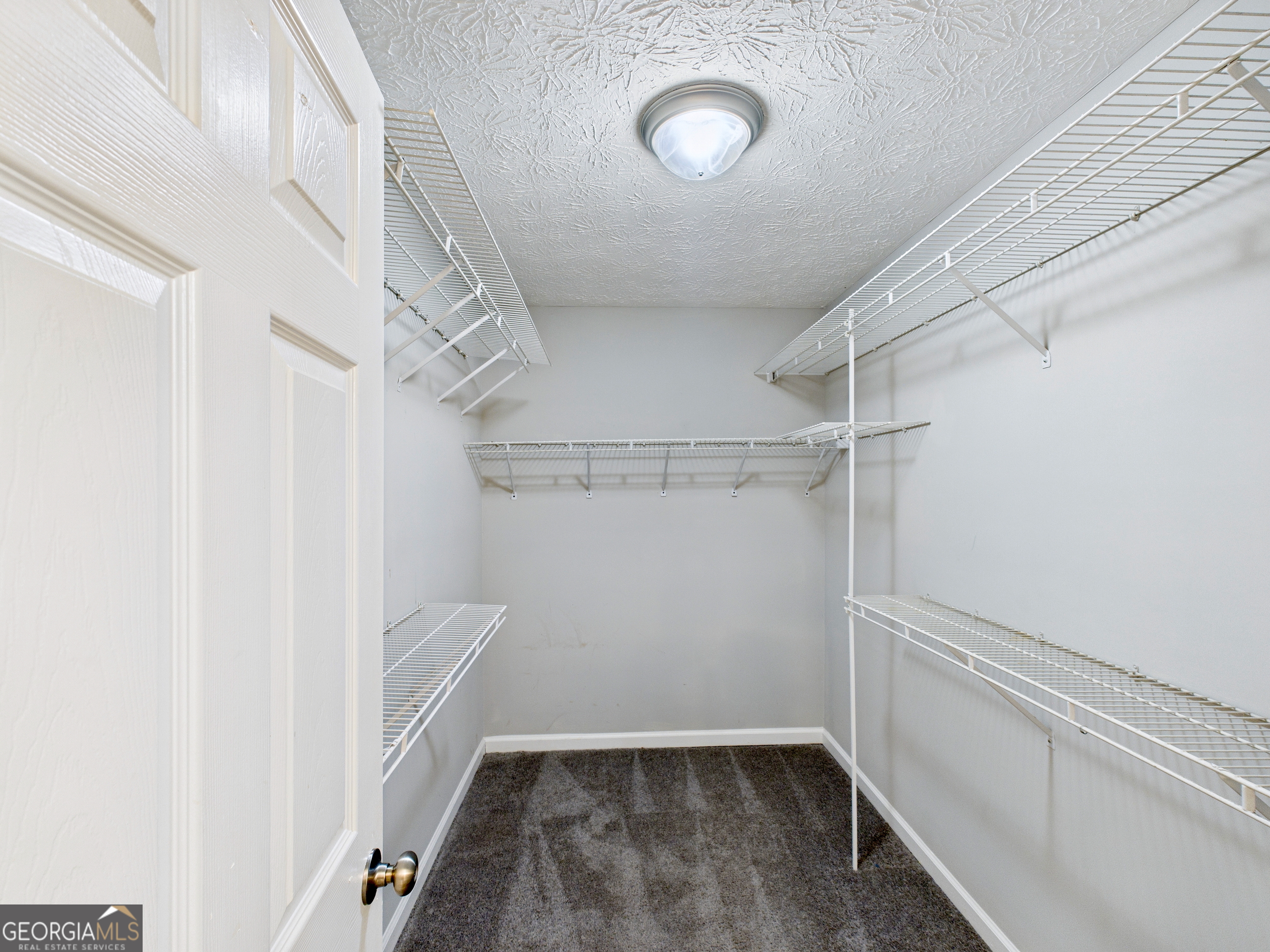 292 Blue Bird Trail Fortson, GA 31808 - Photo 21 of 45 a view of a room with racks on the wall