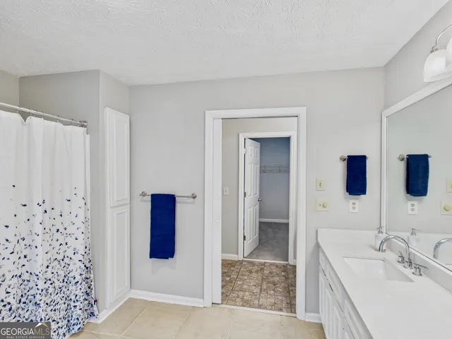 a bathroom with double vanity and a mirror