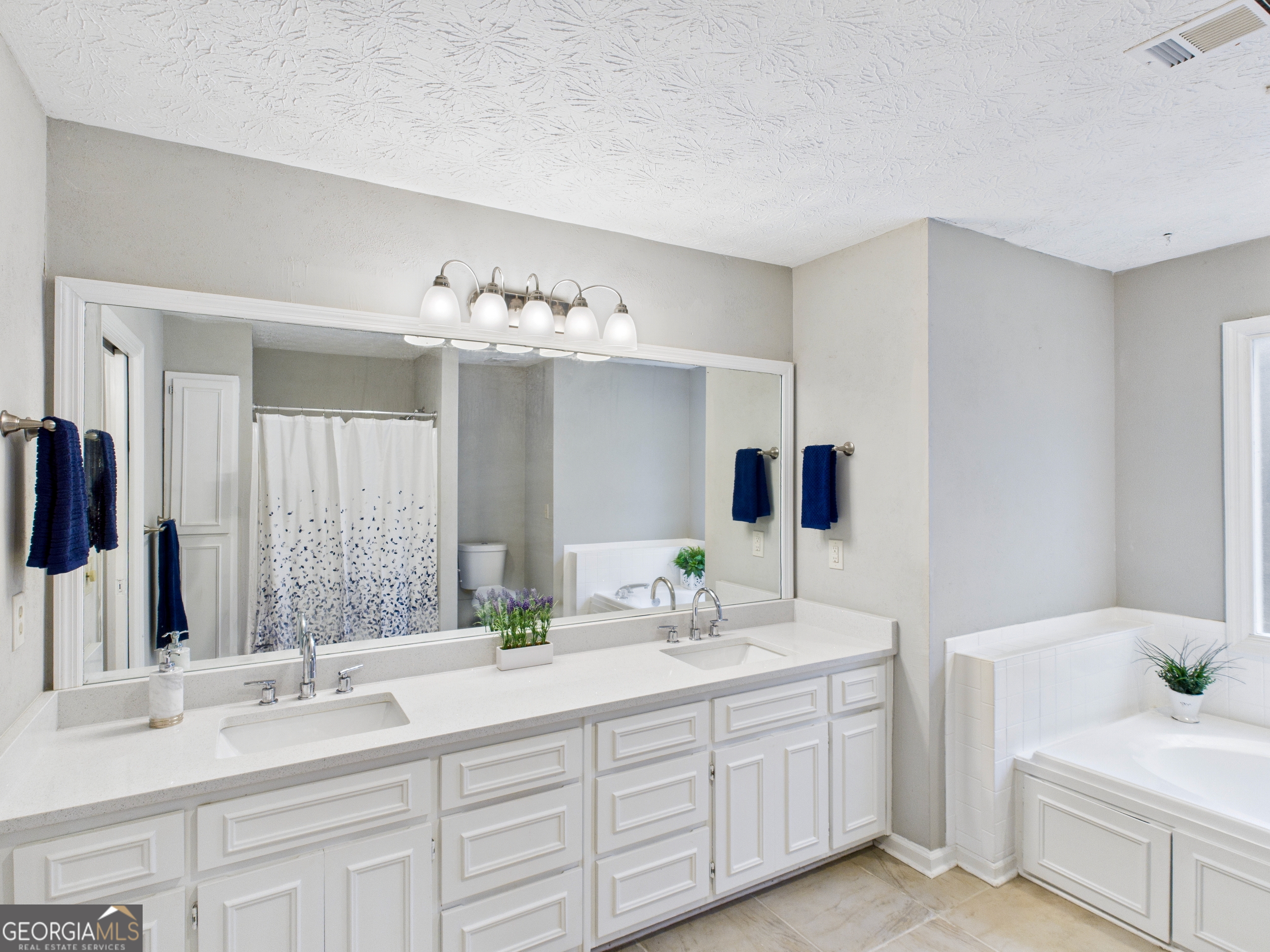 292 Blue Bird Trail Fortson, GA 31808 - Photo 24 of 45 a bathroom with double vanity sinks and a mirror